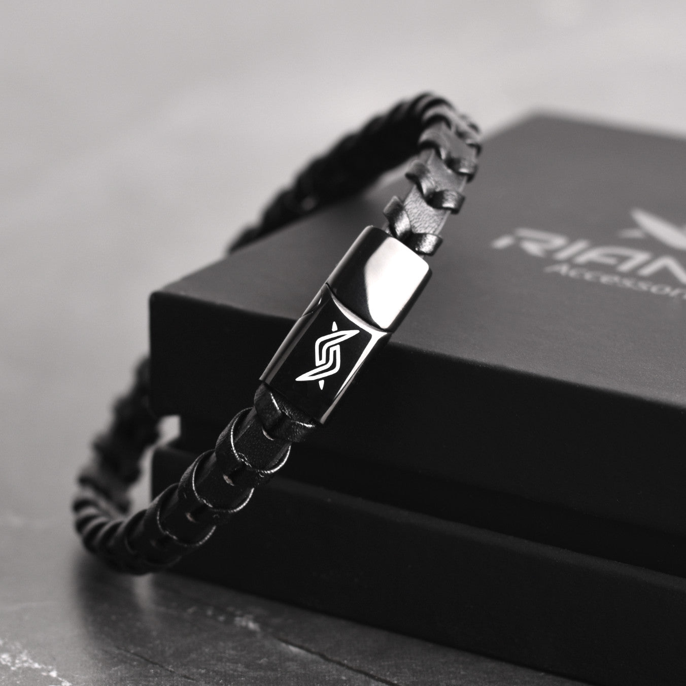 Leather bracelet with fishbone pattern and branded stainless steel clasp, back view